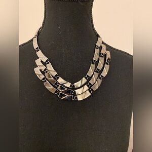 Gunmetal toned 3-tier necklace.